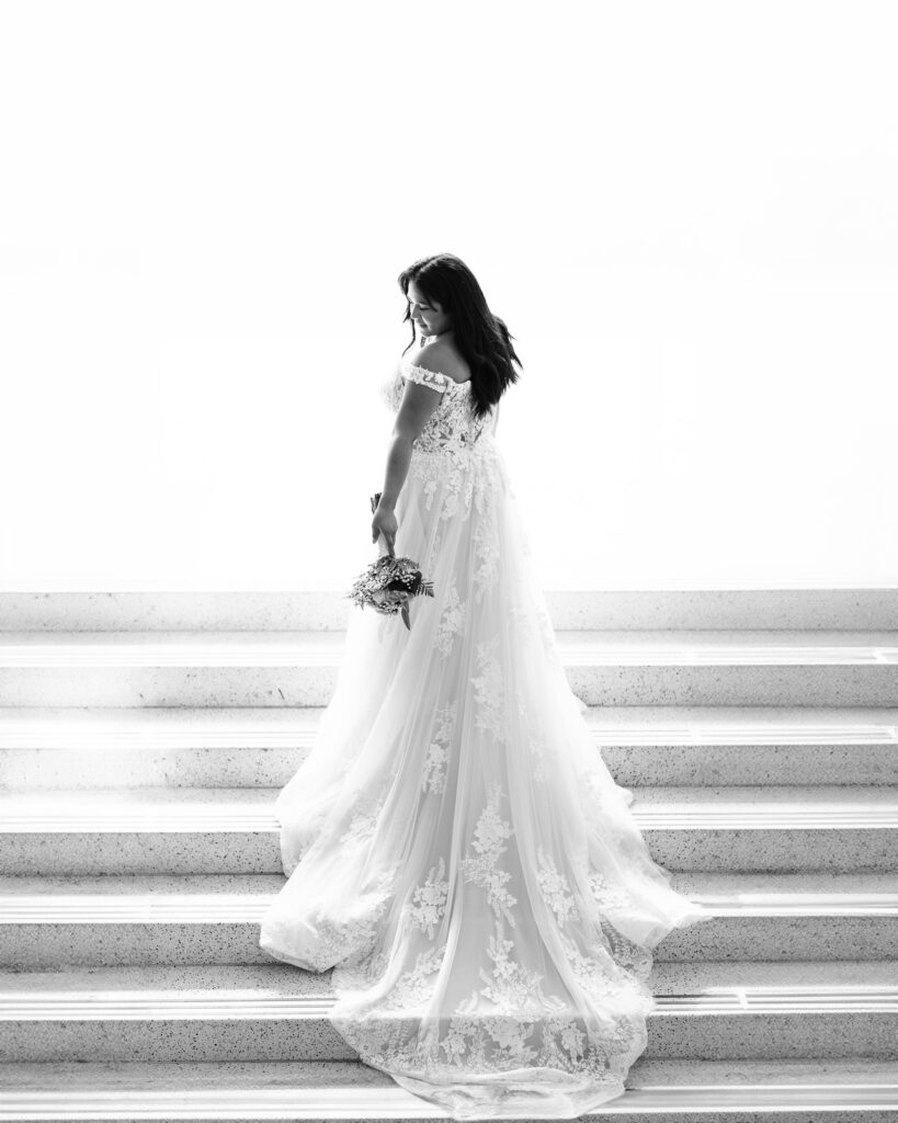 newly married bride showing her dress at the durham courthouse after their wedding 