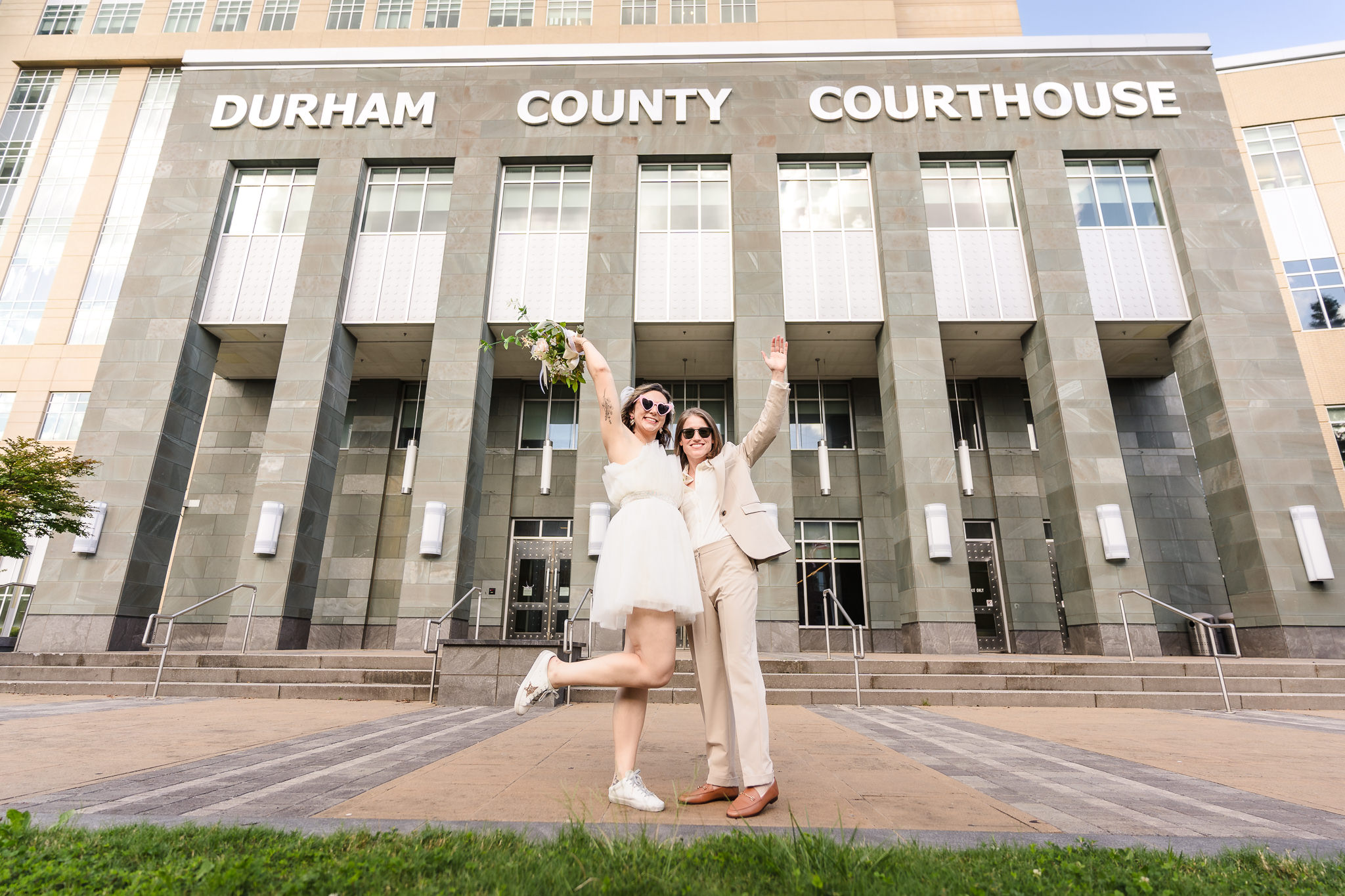 Newly married couple celebrating after a wedding at Durham courthouse